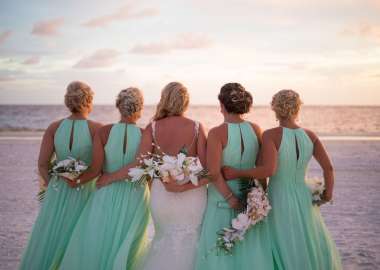 Beautiful Bride and Bridesmaids in Wedding Party Looking out at